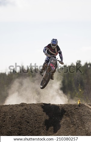 LAITILA, FINLAND - APRIL 20: A motocross driver jumps in a track. Image taken in West Cross Weekend championships in Laitila, Finland in April 20th 2014.