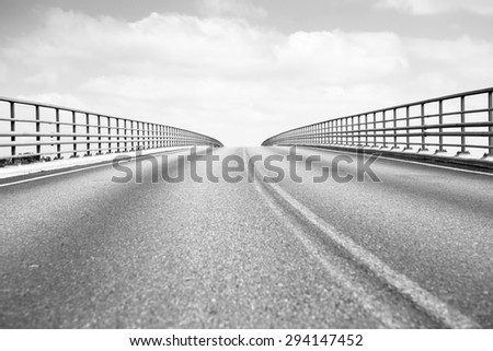 A road to heaven. Image of a bridge going to the sky with clouds. Image has a vintage effect to give an artistic flavor.