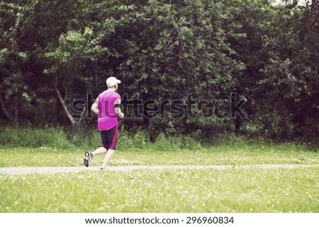 A woman running in the rain. Image has a vintage effect.