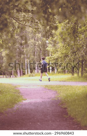 A man running in the rain. Image has a vintage effect.