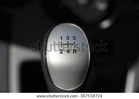 A macro shot of a gear stick. The knob is from a quite new 5-speed manual car. Image taken with natural light using a macro lens.