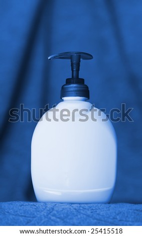 Unbranded bottle with batcher on towel background in duo-tone blue