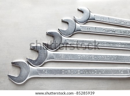 Macro of wrenches tool kit over steel background