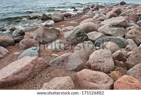 stones on the beach and the tide on a cloudy day