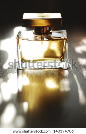 Golden Perfume Golden perfume bottle on a natural background