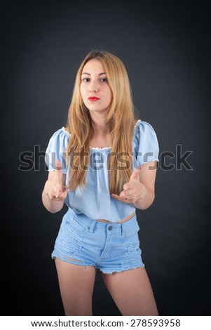 Beautiful girl doing different expressions in different sets of clothes: gun sign