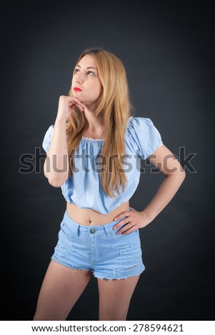 Beautiful girl doing different expressions in different sets of clothes: thinking