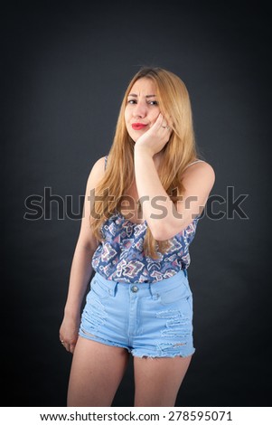 Beautiful girl doing different expressions in different sets of clothes: toothache