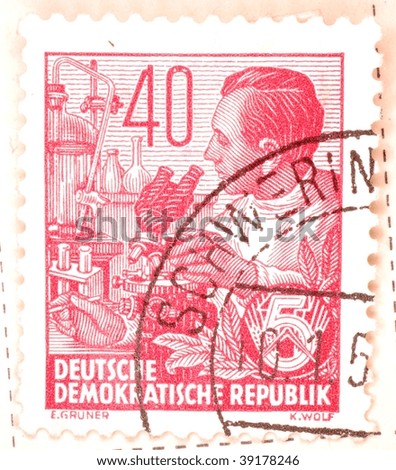 EAST GERMANY - CIRCA 1956: A stamp printed in East Germany shows image of a scientist with a microscope, series, circa 1956