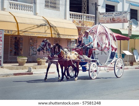 HAMMAMET, TUNISIA - JUNE 30: Tourists ride in a carriage in the resort town of Hammamet on June 30th, 2010. Tourism provides 15% of the jobs in Tunisia.