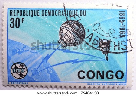 DEMOCRATIC REPUBLIC OF CONGO - CIRCA 1965: A 30 franc stamp from the Democratic Republic of Congo shows image of the Earth and satellites, circa 1965