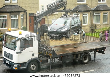EDINBURGH - JUNE 11: a car is uplifted on June 11, 2011 in Edinburgh, Scotland. The car was parked illegally on the route of the Leith Gala Day Parade.