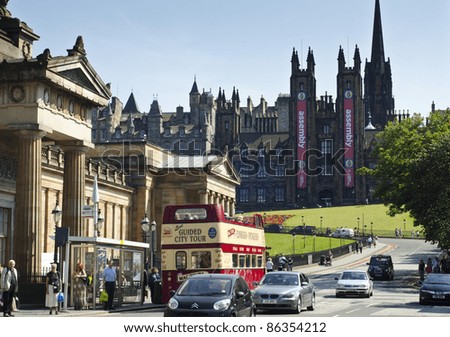 EDINBURGH - JULY 30: a vintage tour bus at The Mound with the Free Church of Scotland behind on July 30, 2011 in Edinburgh, Scotland. Edinburgh is the UK's second most visited tourist destination.