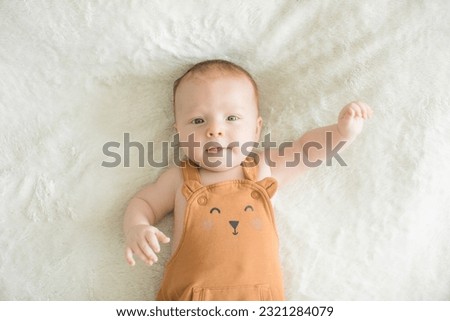 Similar – Image, Stock Photo 3 month old baby doing tummy time; bohemian interior room with houseplants