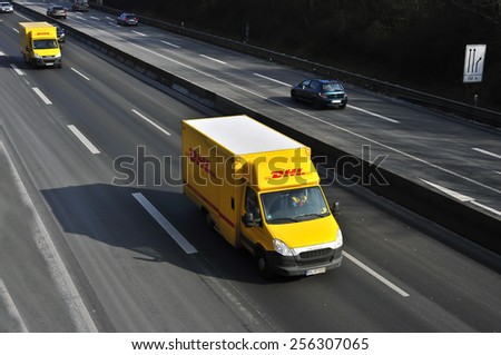 MAINZ, GERMANY - FEB 20: DHL delivery van on the highway on February 20, 2015 in Mainz, Germany. DHL is a world wide courier company that operates in 220 countries with over 285,000 employees.