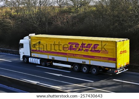 MAINZ, GERMANY - FEB 20: DHL delivery truck on the highway on February 20,2015 in Mainz, Germany. DHL is a world wide courier company that operates in 220 countries with over 285,000 employees.