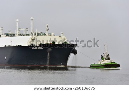 KLAIPEDA,LITHUANIA- FEB 28:GOLAR SEAL LNG Tanker and green tug in the Baltic sea on February 28,2015 in Klaipeda,Lithuania. GOLAR SEAL IMO 9624914 is LNG Tanker, registered in Marshall Islands.