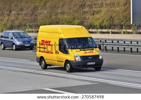 FRANKFURT,GERMANY - MARCH 28: DHL delivery van on the highway on March 28,2015 in Frankfurt, Germany. DHL is a world wide courier company that operates in 220 countries with over 285,000 employees.