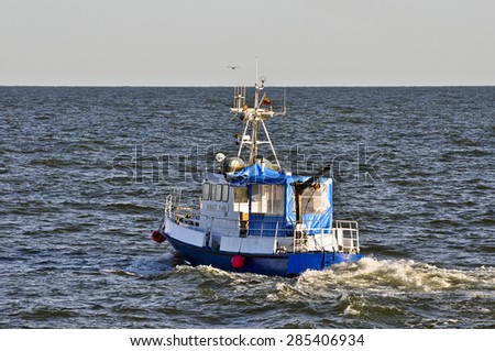 KLAIPEDA,LITHUANIA- JUNE 05: red fishing boat in Baltic Sea on June 05,2015 in Klaipeda,Lithuania.