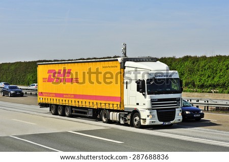 FRANKFURT,GERMANY - APRIL 10: DHL delivery truck on the highway on April 10,2015 in Frankfurt, Germany. DHL is a world wide courier company that operates in 220 countries with over 285,000 employees.