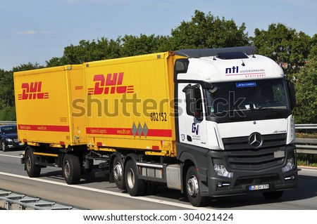 FRANKFURT,GERMANY-JULY 31:DHL delivery truck on the highway on July 31,2015 in Frankfurt,Germany.DHL Express is a division of the German logistics company providing international express mail services