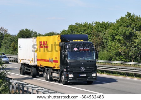 FRANKFURT,GERMANY-JULY 31:DHL delivery truck on the highway on July 31,2015 in Frankfurt,Germany.DHL Express is a division of the German logistics company providing international express mail services