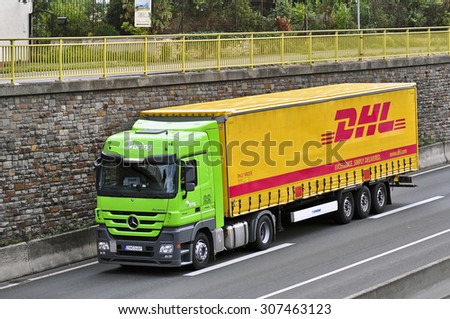 FRANKFURT,GERMANY-AUGUST 18:DHL delivery truck on the highway on August 18,2015 in Frankfurt,Germany.DHL Express is a division of the German logistics company
