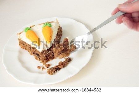 using a fork to eat a slice of carrot cake
