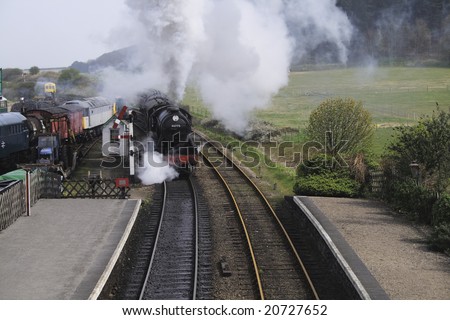 tourism locomotive entering a station where old locomotives are restored