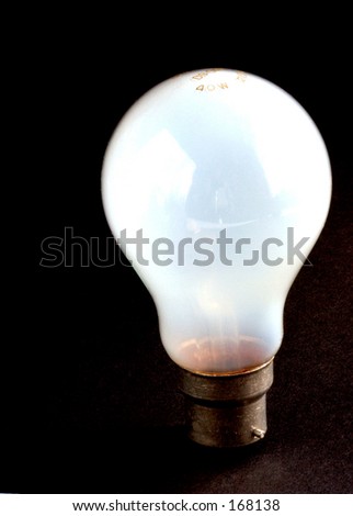 illuminated  light bulb again a black background