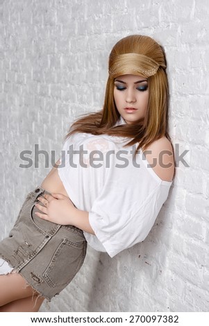 girl in shorts and a t-shirt with hairstyle like a baseball cap