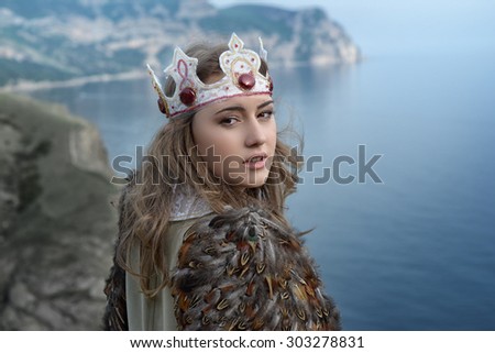 woman dressed as a bird. with a wings and crown on her head