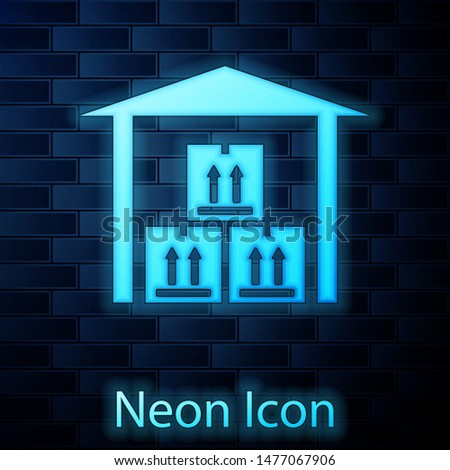 Glowing neon Warehouse icon isolated on brick wall background.  Vector Illustration