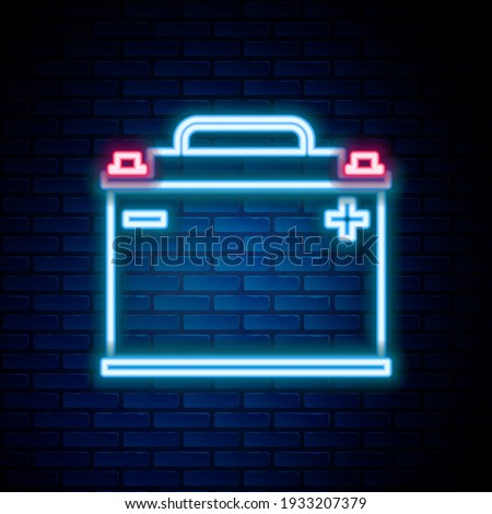 Glowing neon line Car battery icon isolated on brick wall background. Accumulator battery energy power and electricity accumulator battery. Colorful outline concept. Vector