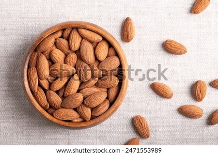 Similar – Image, Stock Photo Bowl of healthy almond chips spilled on wooden table