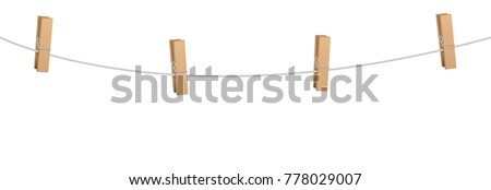 Clothes pins on a clothes line rope  - four wooden pegs holding nothing. Foto stock © 