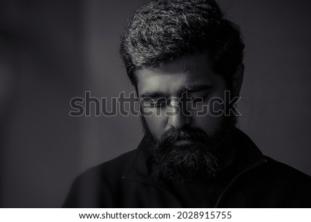 Similar – Image, Stock Photo Portrait of a sad, crouching man in a black hoodie