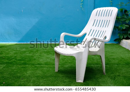 Similar – Image, Stock Photo White plastic garden bench stands on a meadow with yellow flowers