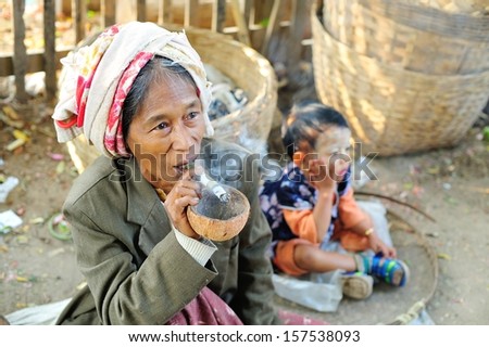 BAGAN, MYANMAR - JANUARY 23 : Portrait of old asian woman smoking traditional tobacco on January 23, 2009 in Bagan, Myanmar.
