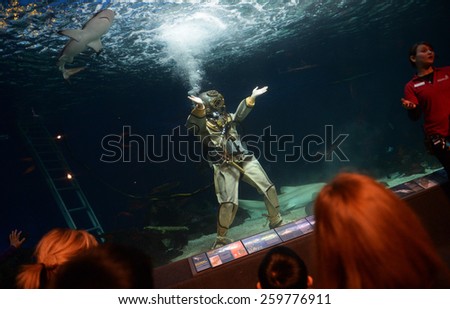 VANCOUVER, CANADA - JANUARY 18, 2015: A diver swims in a shark tank during annual Diver\'s Weekend at Vancouver Aquarium in Vancouver, Canada, on January 18, 2015.