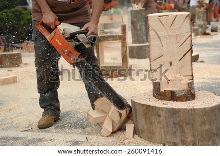 SQUAMISH, BC, CANADA - AUGUST 2, 2013: Loggers demonstrate their chainsaw skills during Squamish Days Loggers Festival in Squamish, BC, Canada, on August 2, 2013.