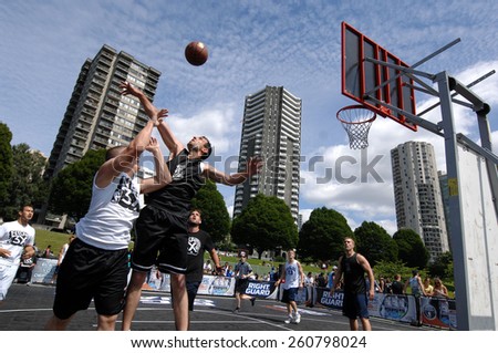 VANCOUVER, CANADA - JULY 29, 2012: Athletes play street basketball at Sunset Beach in Vancouver, Canada, on July 29, 2012.