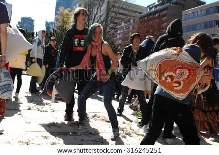 VANCOUVER, CANADA - APRIL 7, 2012: Feathers went flying as hundreds of people came armed with their pillows to celebrate the International Pillow Fight Day 2012 in Vancouver, Canada, April 07, 2012.
