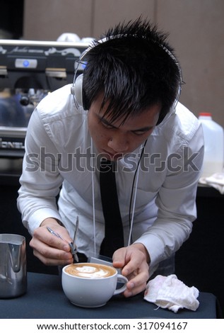 VANCOUVER, CANADA - OCTOBER 19, 2013: A barista prepares a cup of latte during public event to promote coffee beverages in Vancouver, Canada, October 19, 2013.