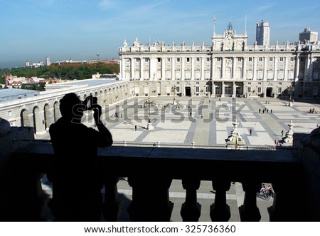 MADRID, SPAIN - OCTOBER 21, 2014: Visitors look at the Royal Palace of Madrid from the Cathedral of Our Lady of Almudena balcony in Madrid, Spain, Oct. 21, 2014.