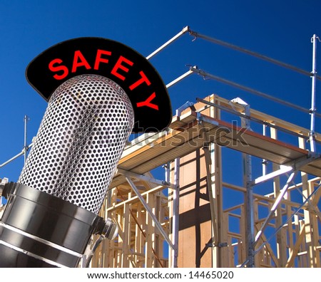 Safety message on vintage microphone with house framing scaffolding in background.  This image is created as a composite of two photographs and text to convey the concept of workplace safety.