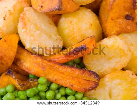 Crisp roast vegetables including potatoes, pumpkin and carrot with peas.