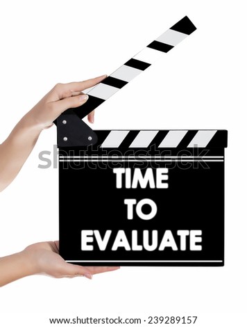 Hands holding a clapper board with TIME TO EVALUATE text