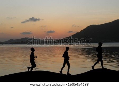 Silhouette running exercise n the evening atmosphere Sunset. Stock fotó © 