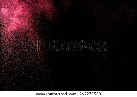 Abstract pink paint Holi. Abstract pink powder explosion on black background.